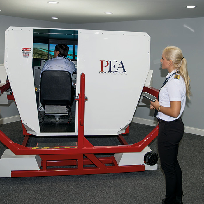 fmx sim in use with instructor standing outside