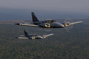 Two piper senecas in flight from photoshoot
