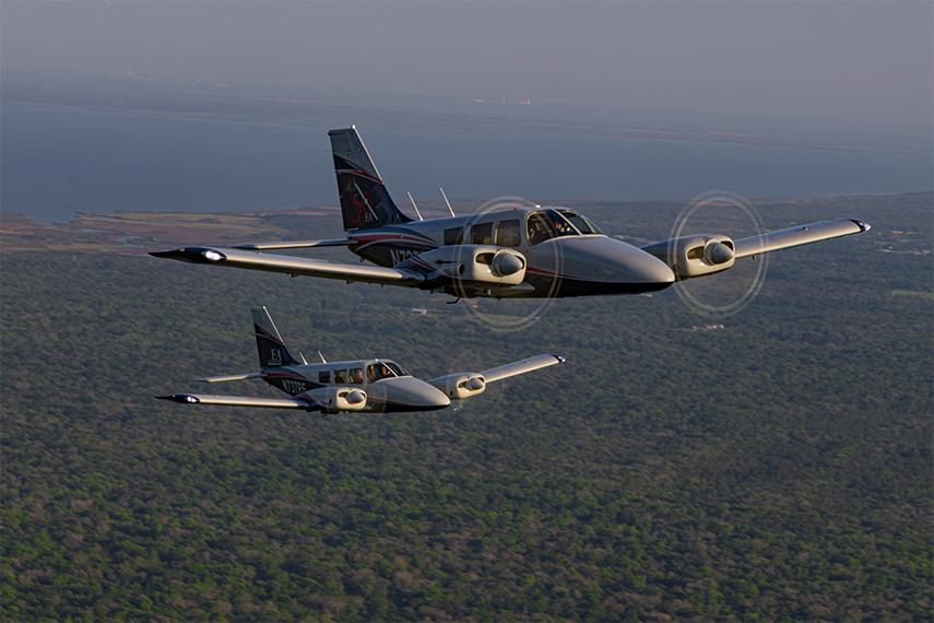 Two piper senecas in flight from photoshoot