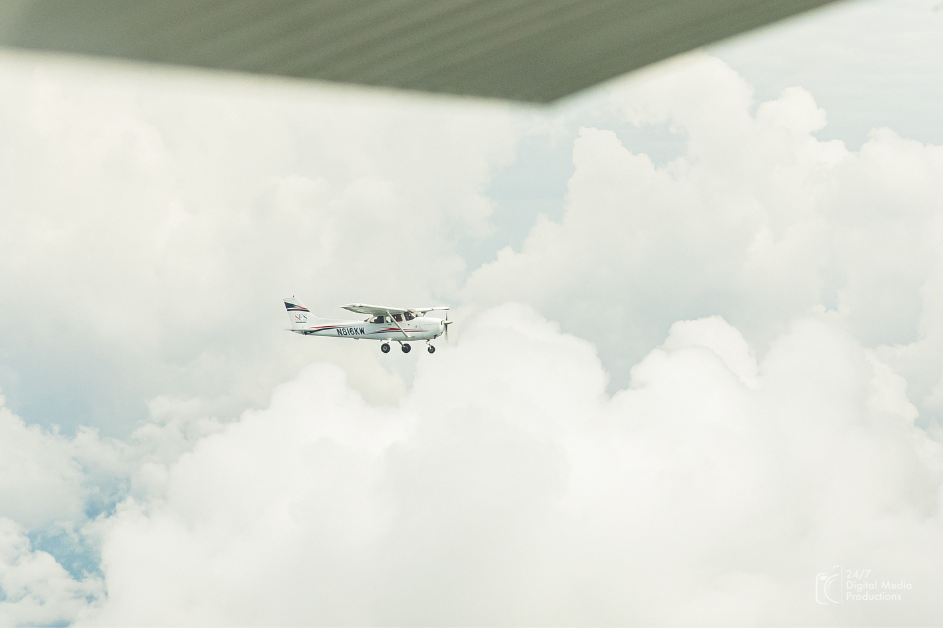White cessna 172 in the clouds from a distance